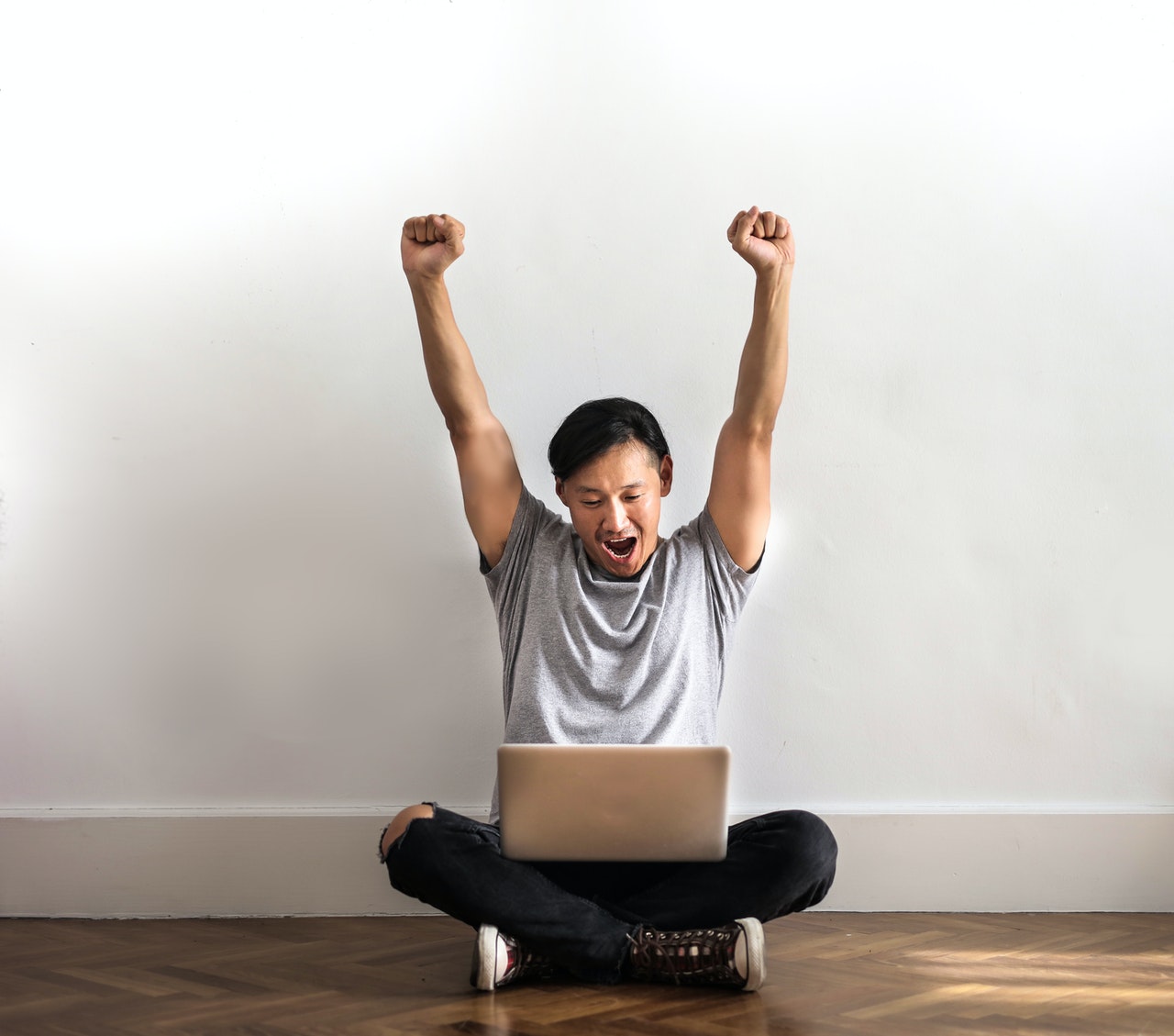 Man celebrates after winning on sports betting online